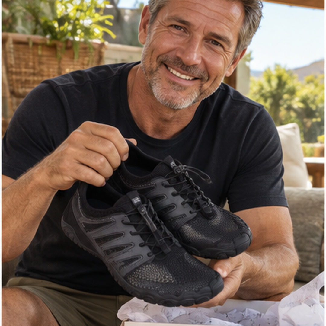 Customer holding black barefoot shoes beside the shoe box