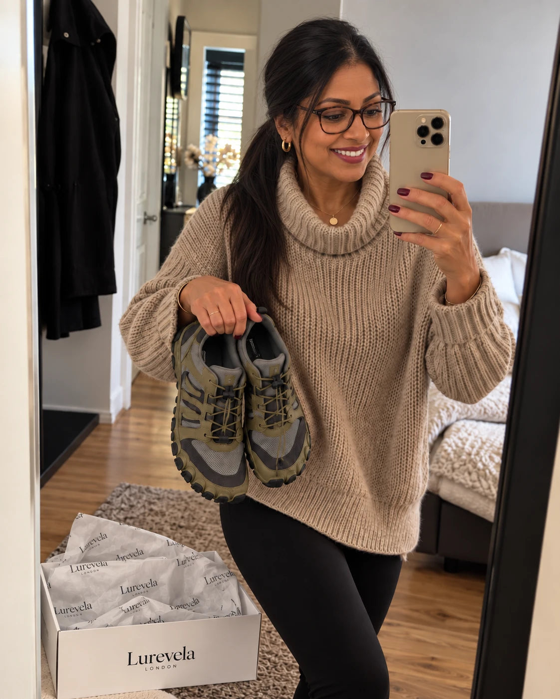 Customer holding olive Lurevela barefoot shoes in a mirror selfie